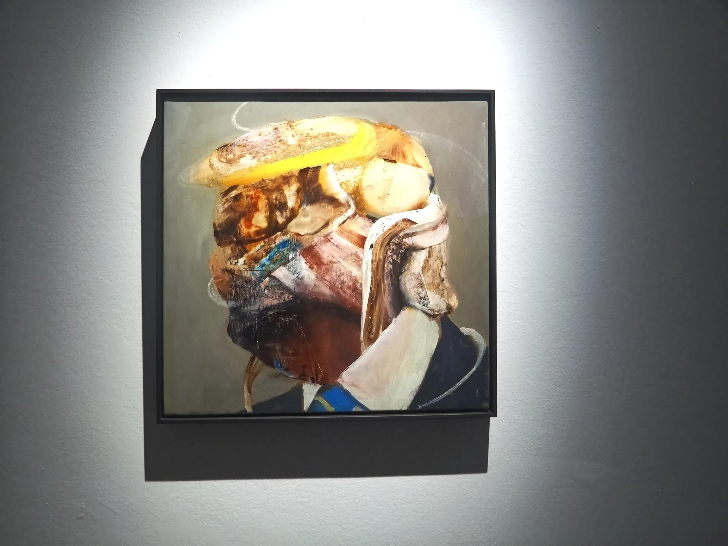A portrait painted by Adrian Ghenie, hung on a white wall