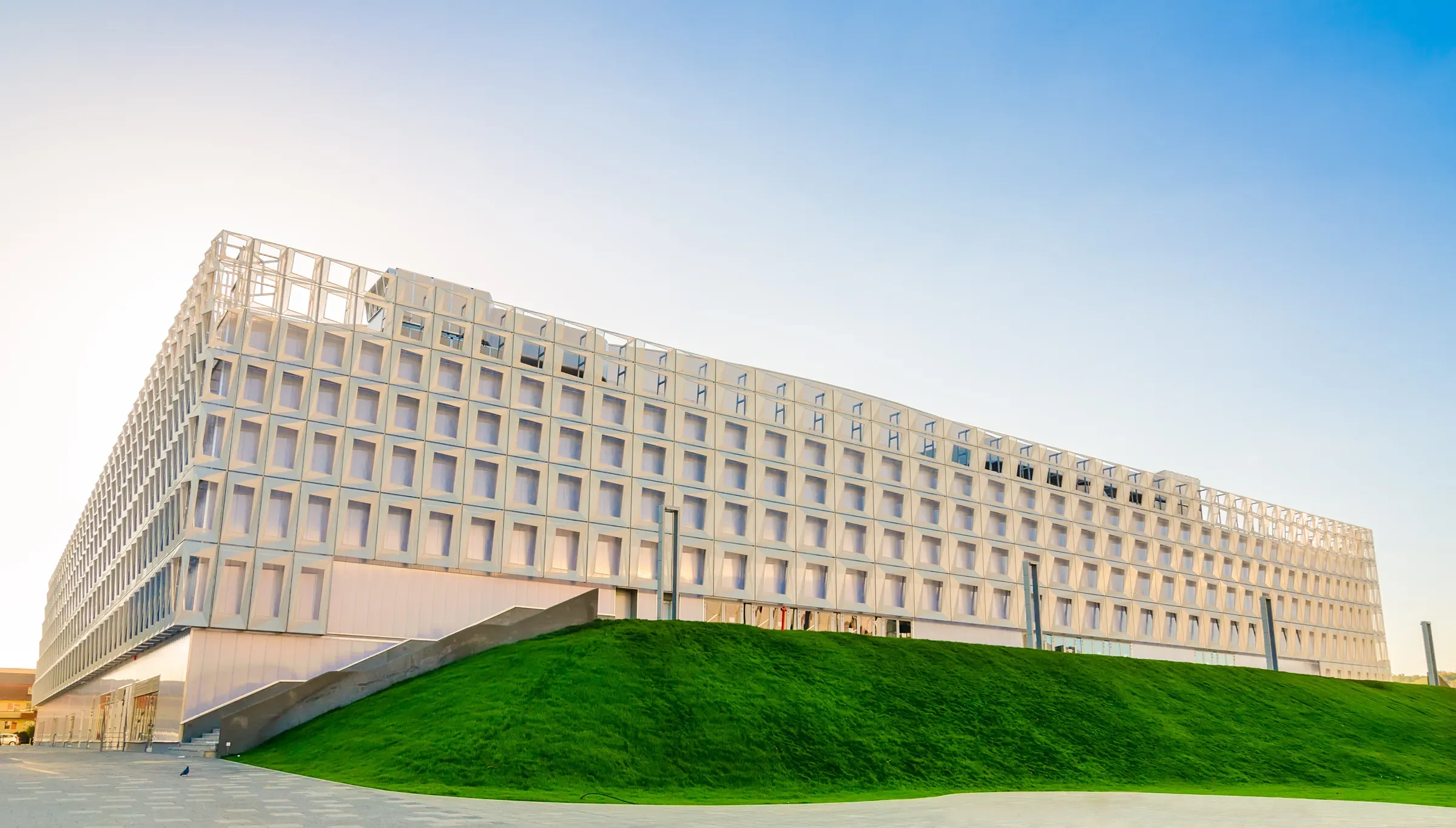 BT Arena, the multipurpose hall next to Cluj Arena, with its white grid facade and grassy bank