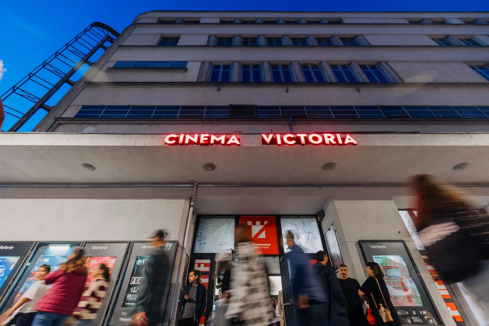 The Cinema Victoria façade in the evening, with its red sign lit