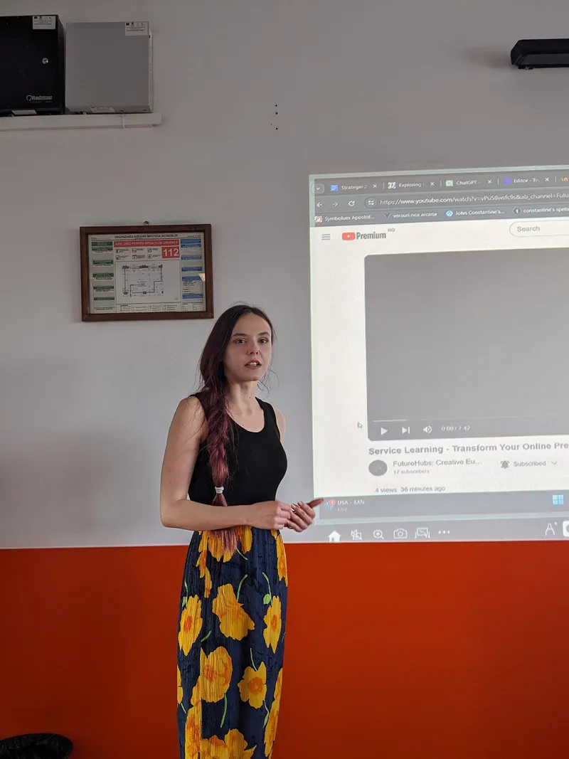 Loredana Vale presenting at the front of the room, in front of the projected screen